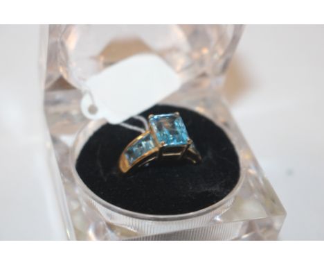 A yellow metal ring marked 10K, set with blue stones, ring size L, approx. 4gms