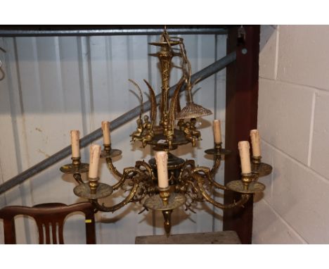 An ornate gilded and bronzed eight light chandelier