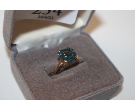 A yellow metal ring marked 14K, set with blue stone, ring size L, approx. 3gms 