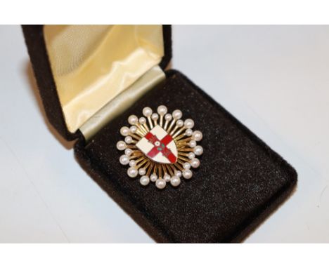 A silver gilt and enamel decorated brooch, London 2008 by Grant McDonald Silversmiths decorated with seed pearls and enamelle