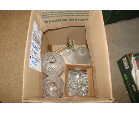A box containing a quantity of glass lamp shades