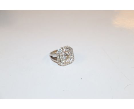 A white metal ring set with approx. 1carat diamond surrounded by two bands of smaller diamonds, ring size K/L, approx. total 