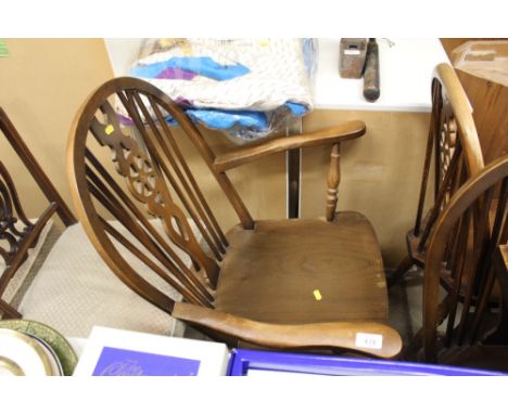 An elm seated stick and wheel back rocking chair 