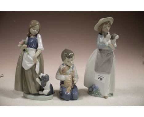 THREE NAO FIGURES OF CHILDREN WITH DOGS 