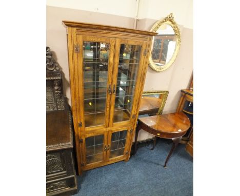 A LIGHT OAK GLAZED FLOOR STANDING BOOKCASE