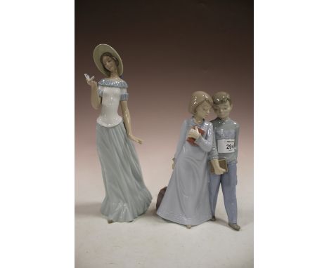 A NAO FIGURE OF TWO YOUNG STUDENTS PLUS  A NAO LADY WITH A BUTTERFLY 