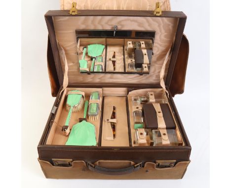 An Art Deco leather travelling vanity case, by Carmichael of Hull, with all green enamel internal fittings and jars, with rem