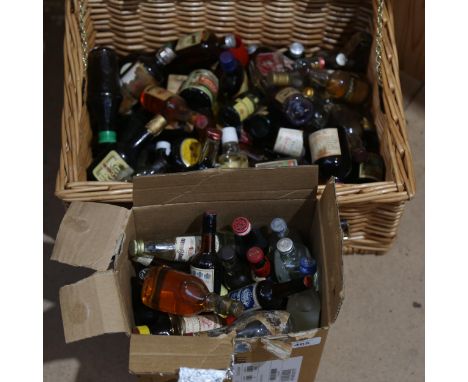 A wicker hamper containing a quantity of miniature liquor bottles, including liqueurs and Whisky, and a small box of miniatur