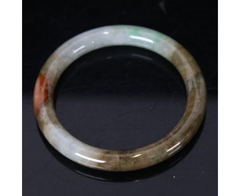 A Chinese carved and polished jade slave bangle 