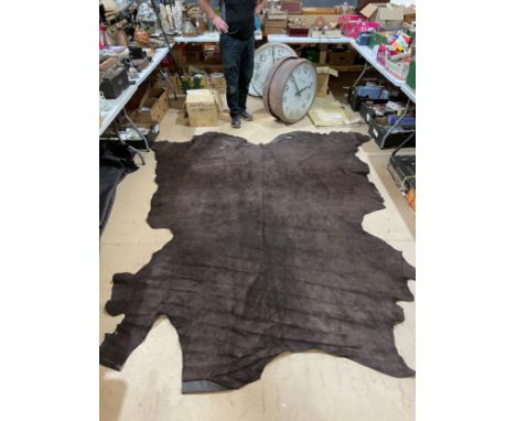 3 full dark brown leather hides: 290x250cm, 250x230cm, 250x220cm and one half light brown leather hide: 190x160cm.
