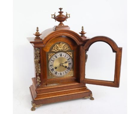 A German walnut dome-top 8-day mantel clock, by Junghans, brass dial with silver chapter ring, and movement striking on 2 gon