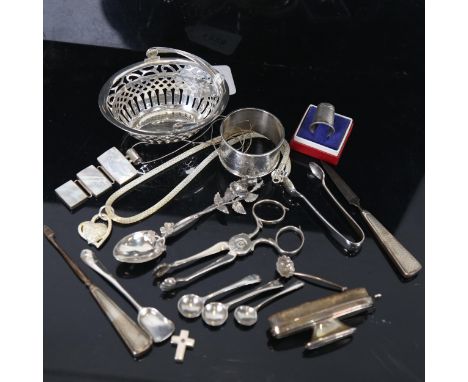 A collection of silver items, to include a pierced swing-handled basket, sugar nips, a Chinese napkin ring, manicure items et