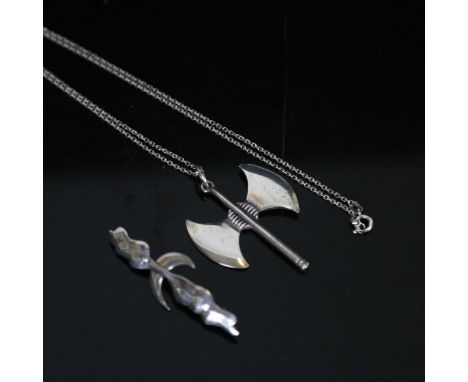 A sterling silver pendant and chain in the form of a Viking axe, and a Viking style silver brooch 