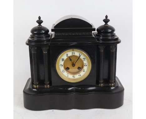A large black slated architectural 8-day mantel clock, movement striking on a gong, case height 29cm 