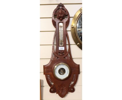 An Art Nouveau oak aneroid barometer, length 68cm 