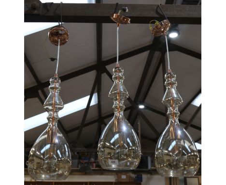 A set of 3 glass pendant light fittings with copper mounts, lamp height 44cm 
