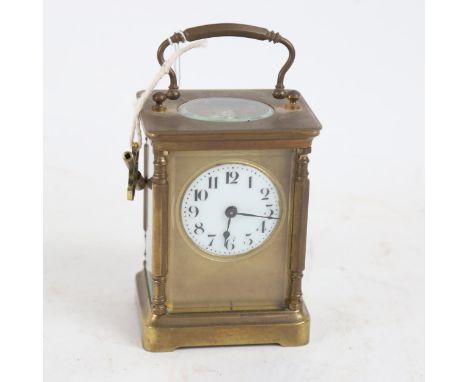 A brass-cased carriage clock, white enamel dial with Arabic numerals, case height 11cm 