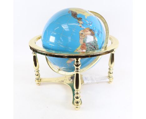 A reproduction brass and hardstone table-top terrestrial globe, with compass inset base, overall height 45cm, globe diameter 