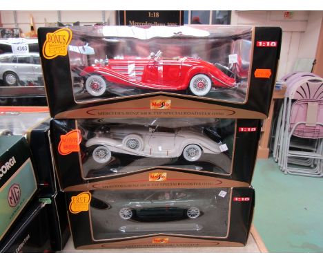 Three boxed Burago Special Collection 1:18 scale diecast cars to include Aston Martin DB7 Vantage and two Mercedes-Benz 500 K