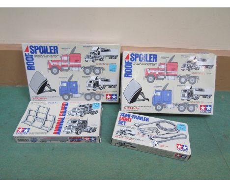 Four boxed Tamiya 1:14 scale radio control truck accessories, Roof Spoiler (x2), Semi-Trailer Light Set and Animal Guard 