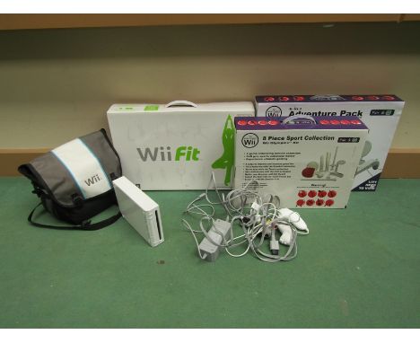 A Nintendo Wii computer games console in carry case with various games including Super Mario Bros., Wii Fit, controllers and 
