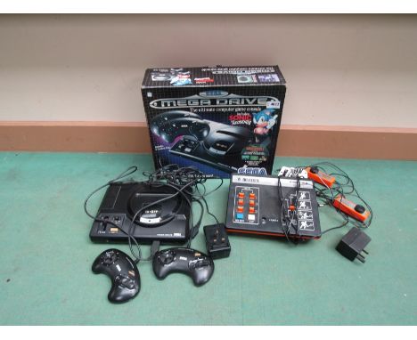 A boxed Sega Mega Drive computer game console with two controllers and a Binatone TV game (2) 