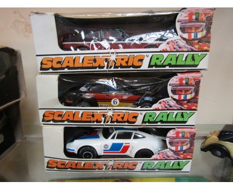 Three boxed Scalextric Rally slot racing cars; C.115 Porsche Turbo 935, C117 3.0 Ford Capri and C.117 3.0 Ford Capri and C.10