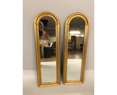 Pair of modern long arch topped wall mirrors, each approximately 32 x 107cm