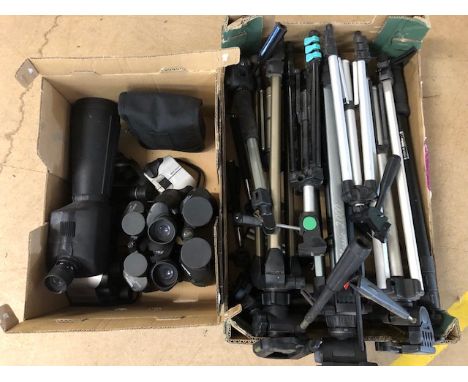 Several pairs of modern binoculars and a spotting scope, along with a collection of tripod stands in various sizes 