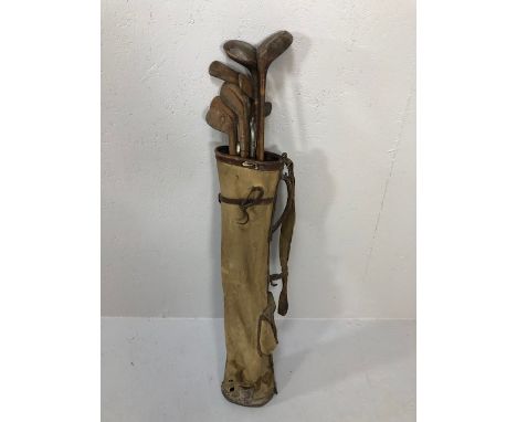 Antique and vintage sporting equipment, set of golf clubs, woods, irons and putters in canvas bag 