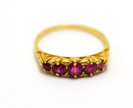 # A ruby and diamond ring, five graduated mixed cut rubies with rose cut diamond accents, in yellow claw settings, finger siz