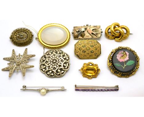 # Eleven brooches, including; a chalcedony brooch, a white metal Celtic design brooch, a citrine brooch, a silver bird and iv