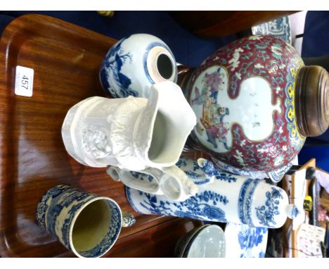 A blue and white floral decorated coffee pot with hinged lid, a 20th century polychrome decorated jar and cover on hardwood s