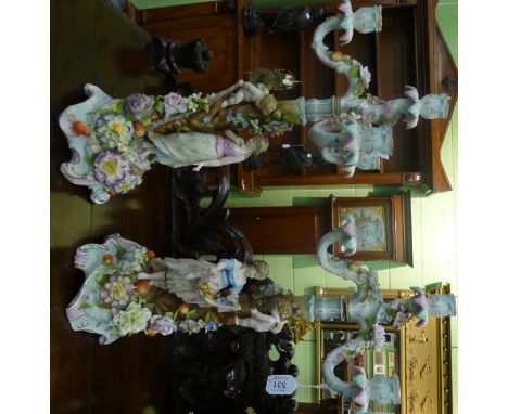 A pair of 19th century German floral encrusted figural four light candelabra, Coburg factory mark, height 54cm, together with