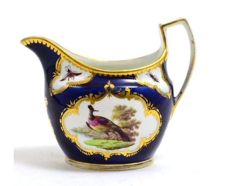 A blue and gilt decorated cream jug with painted reserve depicting fancy birds, circa 1800 CONDITION REPORT: Typical surface 
