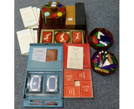 Gaming items comprising: set of 1930s chips in wooden stand, two boxed sets of dominoes, Canasta with score cards, Calypso, M