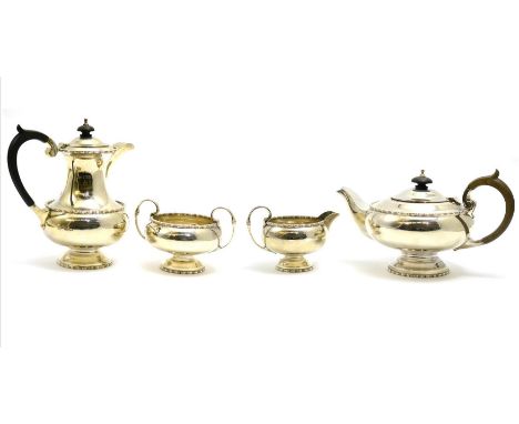 A silver four piece tea service, Sheffield hallmark CONDITION REPORT: Sugar bowl with large dent, cover of hot water jug does