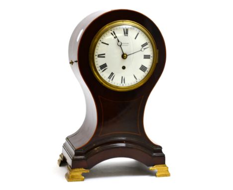 A mahogany balloon mantel timepiece, balloon shaped case with inlay, bracket feet, 5-1/2-inch enamel dial bearing an inscript