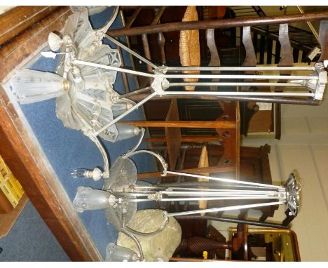 Two French Art Deco silvered metal and frosted glass four-light chandeliers, each with moulded panels and four hanging shades