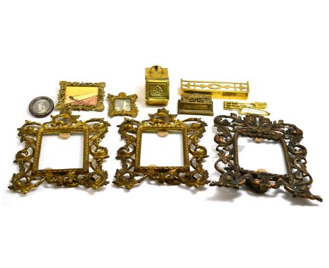 A collection of brass miniature fire irons, coal scuttle, two miniature frames, a silver frame, stamp box and three gilt cast