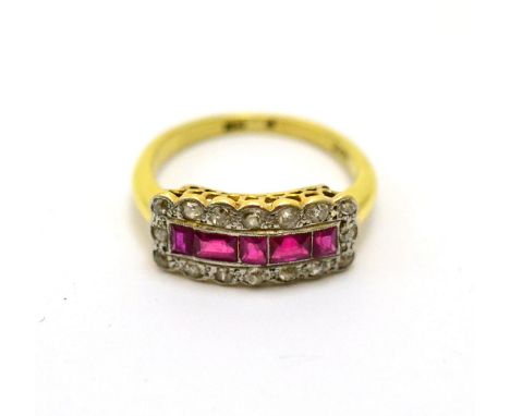 A ruby and diamond ring, the calibré cut rubies within a border of diamonds, finger size Q CONDITION REPORT: The ring is in f