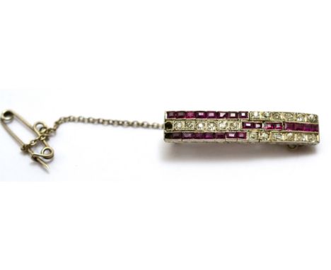 An Art Deco ruby and diamond brooch, old cut diamonds and calibré cut rubies in white millegrain settings, total estimated di