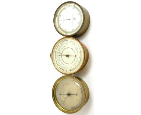 Three brass cased aneroid barometers, 4-1/2-inch silvered dial signed Holosteric barometer T.S&J.D.Negus Navigation Warehouse