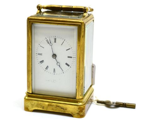 A brass striking carriage clock, circa 1890, carrying handle, enamel dial with Roman numerals, twin barrel movement with a si