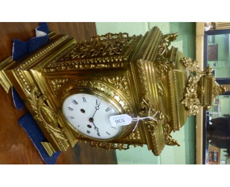 A gilt metal striking mantel clock, circa 1890, the elaborate case with swag and scroll decoration, 5-1/4-inch enamel dial wi