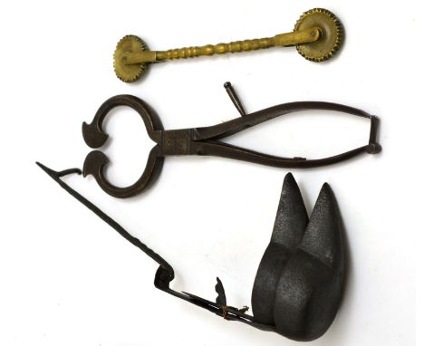 An 18th century crusie lamp, pair of sugar cutters and an early brass pastry frigger (3) CONDITION REPORT: Sold as seen unles