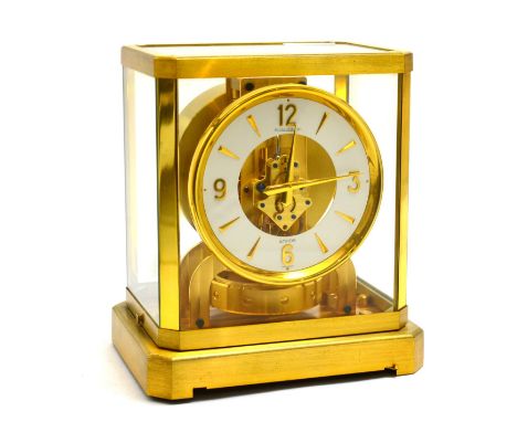 An atmos clock, signed Jaeger LeCoultre, 20th century, white chapter ring with dagger and Arabic numerals, skeletonised dial 