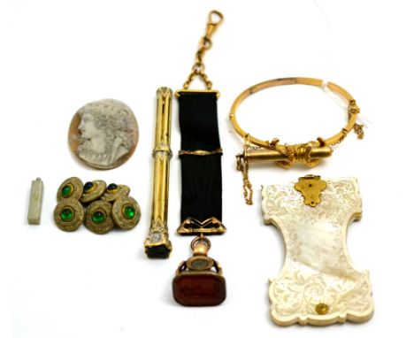 An Edwardian bangle mounted with a S Mordan & Co propelling pencil, a 19th century seal, a cameo, six buttons and a seal top 