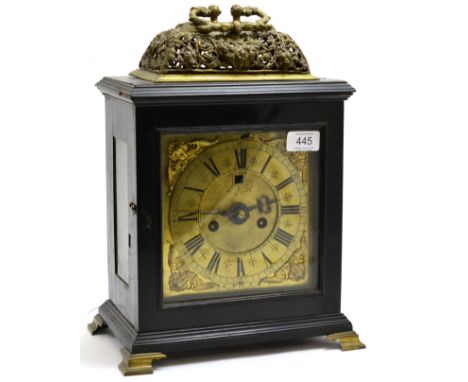 An ebony veneered striking table clock, pieced basket top case with a carrying handle, glazed side panels, 7-inch brass dial 