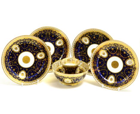A Chamberlain Worcester blue and gilt cup with ring handle and saucer, matching slop bowl and four plates, circa 1815 CONDITI